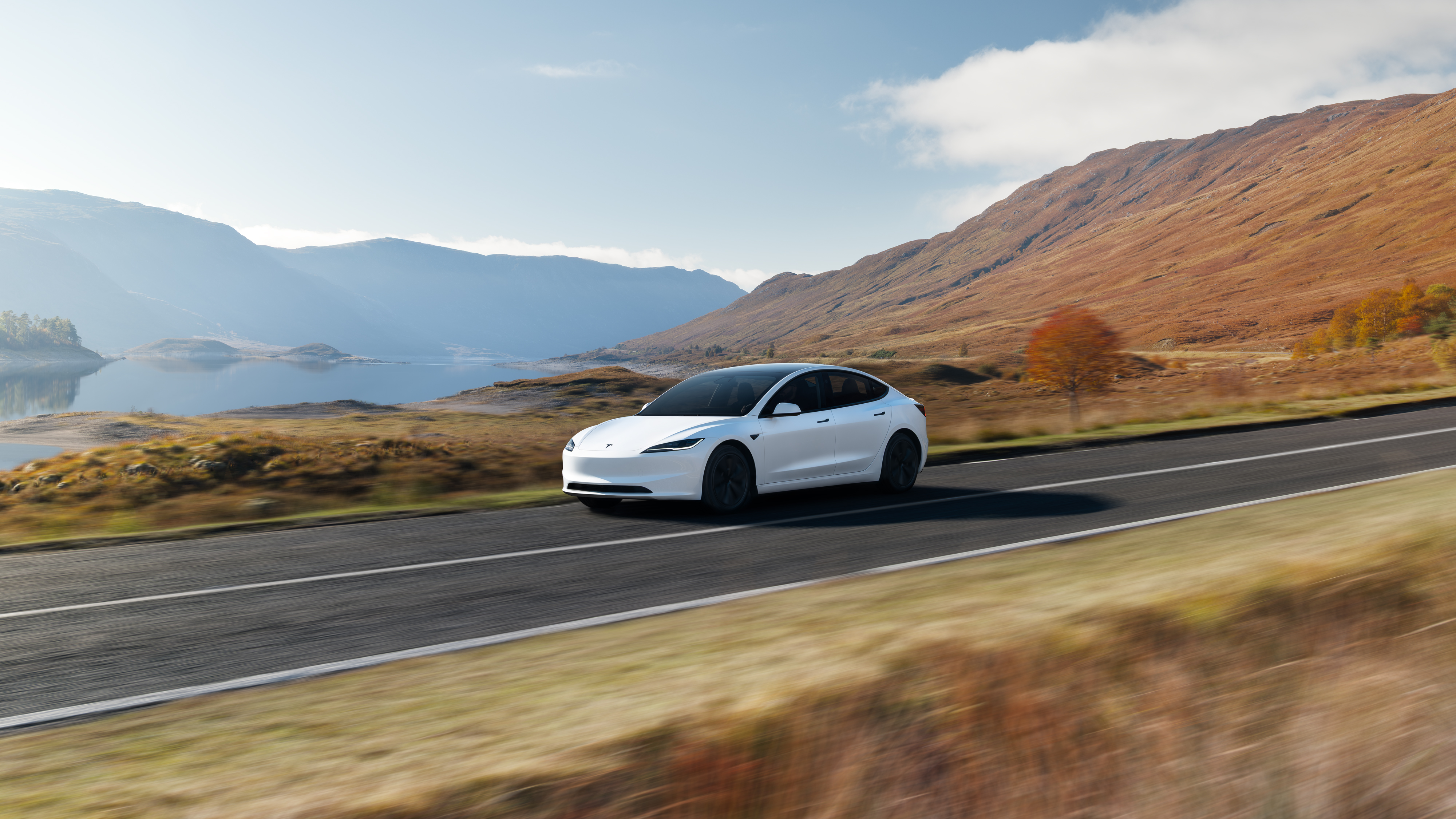 Tesla Model 3 Premium driving along a mountain road